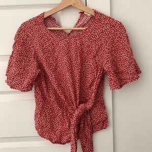 Red flowered blouse with a tie strap to style different ways